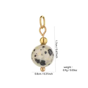 Natural stone round bead pendant detail, gold plated metal accessory component close up.