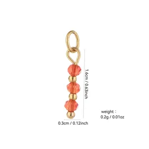 Detail view of gold-plated DIY jewelry pendant charm featuring orange crystal beads.