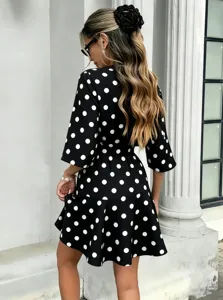 Black and white polka dot summer mini dress featuring a stylish V-neck, high waist, and fit.