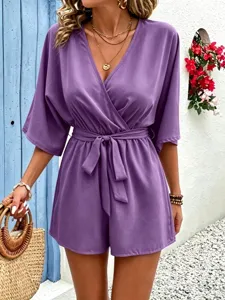 Detail shot of elegant purple v-neck wrap romper with half sleeves and waist tie.