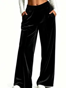 Black velvet wide leg pants detail showing high waist elastic band and soft draping fabric.