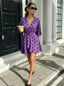 Purple polka dot V-neck wrap dress outdoor street style detail view fashion apparel.