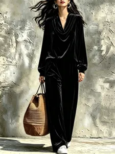 Chic black velvet loungewear set featuring a draped collar long-sleeve top and wide-leg trousers.