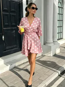 Elegant pink polka dot wrap mini dress detail, featuring a flattering V-neck and high waist.