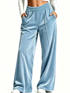 Close-up of velvet wide-leg pants detail, showing soft draped fabric and elastic waist.