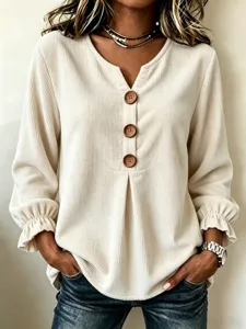 Close-up detail of womens corduroy long sleeve blouse V neck wooden buttons casual shirt top