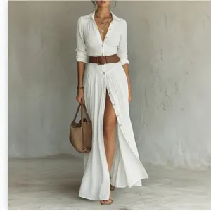 Detailed view of white long sleeve shirt dress with belt, elegant maxi dress design.