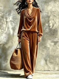 Detailed shot of the brown velvet cowl neck top and straight trousers set in stylish wear.