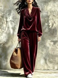 Detailed view of women's burgundy velvet cowl neck top and straight trousers set stylish.