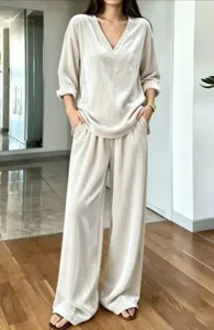 Detailed view of the elegant beige velvet V-neck long sleeve top and matching wide leg pants set.