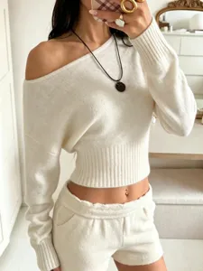 Detail shot of off-shoulder knit crop top, showcasing soft texture and stylish slim fit.