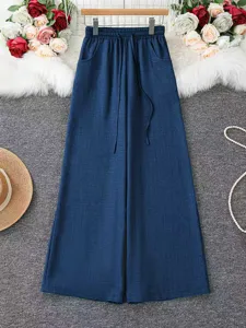 Detail view of women's casual blue ramie wide leg pants with high waist and drawstring design.