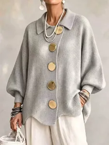 Grey knit cardigan featuring lapel collar, large gold buttons and cozy lantern sleeves.