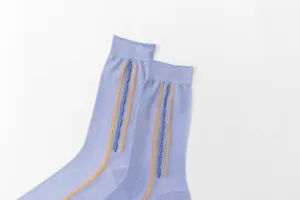 Detailed view of lightweight purple thin socks with vertical yellow and blue striped texture.