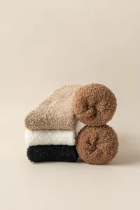 Plush coral fleece fuzzy sleep socks detail, soft warm winter leg warmers stack display.
