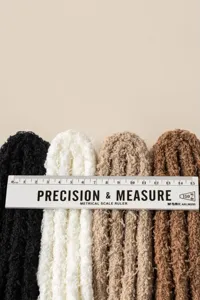 Close-up detail shot of soft fluffy coral fleece winter leg warmers showing soft texture.