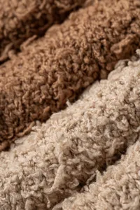Close-up detail of soft coral fleece plush warm leg warmers and cozy winter sleep socks.