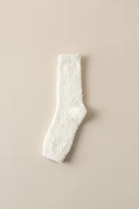 Close-up detail of soft white fleece cozy sleep socks texture surface warmth winter comfort
