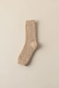 Close up view of cozy coral fleece knit fabric detail on long winter sleep socks.