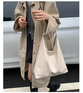 Gedetailleerd overzicht van de informele crèmekleurige schoudertas in streetstyle.