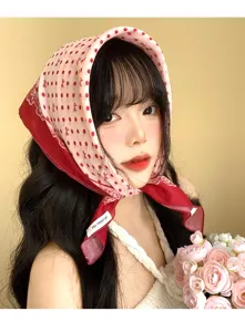 Detail shot of French vintage polka dot bandana head scarf worn by model with flowers.