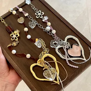 Y2K handmade ribbon pearl beaded heart pendant necklace detail, vintage style aesthetic charm jewelry.