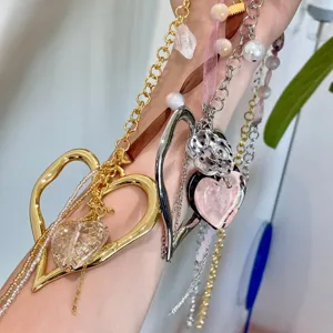 Y2K handmade ribbon beaded heart sweater chain and polka dot flower necklace detail.
