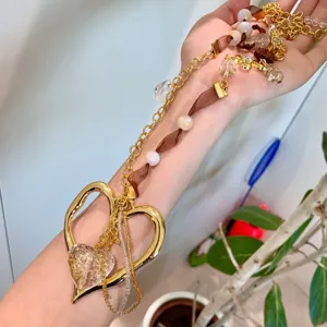 Y2K aesthetic handmade ribbon beaded hollow heart sweater chain necklace detail view.
