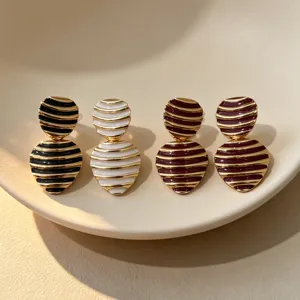Vintage enamel striped geometric earrings French style elegant jewelry detail shot