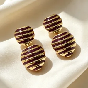 Vintage French enamel double round earrings, gold striped design, elegant jewelry detail.