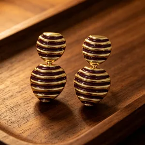 Vintage striped enamel drop earrings, elegant French style gold metal jewelry details.