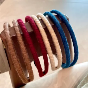 Close-up detail of colorful yarn-wrapped hair hoops, showing double-strand texture.