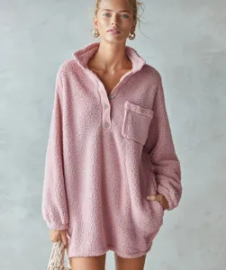 Close up detail view of the cozy pink fleece sherpa dress featuring front buttons and pocket.