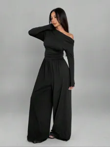 Stylish black one-shoulder long sleeve wide leg jumpsuit detail view showing fit and drape