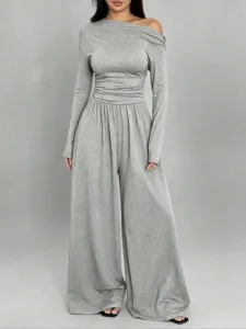 Close-up of the gray one-shoulder long sleeve jumpsuit showing soft fabric and fit details.