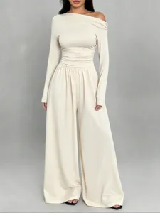 Close-up detail of the elegant off-shoulder long sleeve top and wide-leg jumpsuit outfit.
