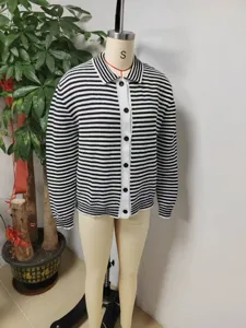 Close-up detail of black and white striped knit cardigan with lapel and buttons.