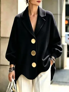 Women oversized black wool coat with statement gold buttons and lapel collar detail.