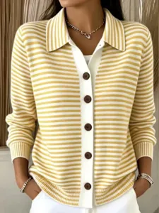 Detail view of yellow white striped knitted cardigan, lapel design with brown buttons.