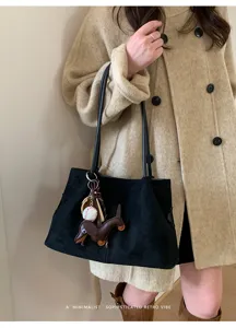 Stylish black suede shoulder tote bag with cute dachshund charm for women daily commute.