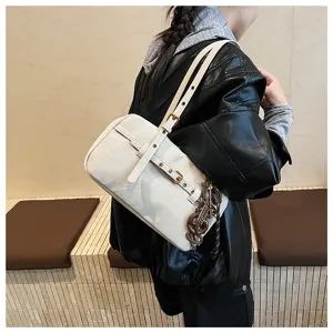 Detailed view of the stylish white retro boston shoulder bag with buckle strap and chic charms.