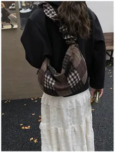 Detailed shot of retro plaid patchwork shoulder bag, casual street style for autumn season.