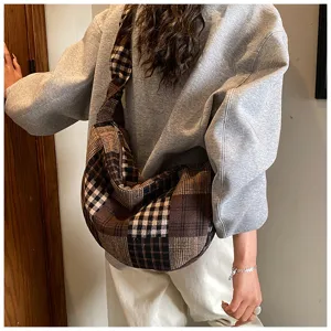 Detailed view of retro plaid hobo shoulder bag, showing slouchy canvas texture and style.
