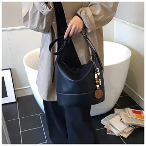 Stylish black PU leather bucket shoulder bag for women, trendy autumn winter cross-body purse.
