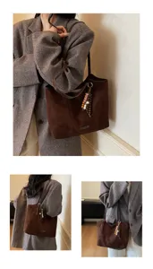 Retro brown suede tote bag detail, featuring stylish wooden bead charm and shoulder strap.