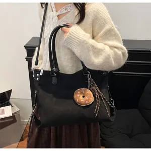 Stylish black canvas tote bag for women with donut charm, large capacity casual daily commuting handbag.