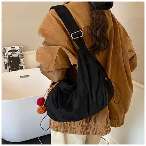 Retro black suede underarm crossbody bag for women, casual autumn shoulder tote with charm.