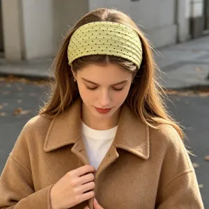 Gros plan d'un élégant bandeau à pois jaunes porté par un mannequin à l'extérieur dans la rue.