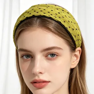 Detailed closeup of a stylish yellow polka dot pleated wide headband, perfect for daily fashion.