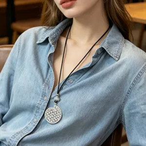 Silver hollow round pendant long necklace with black cord, stylish sweater chain accessory.